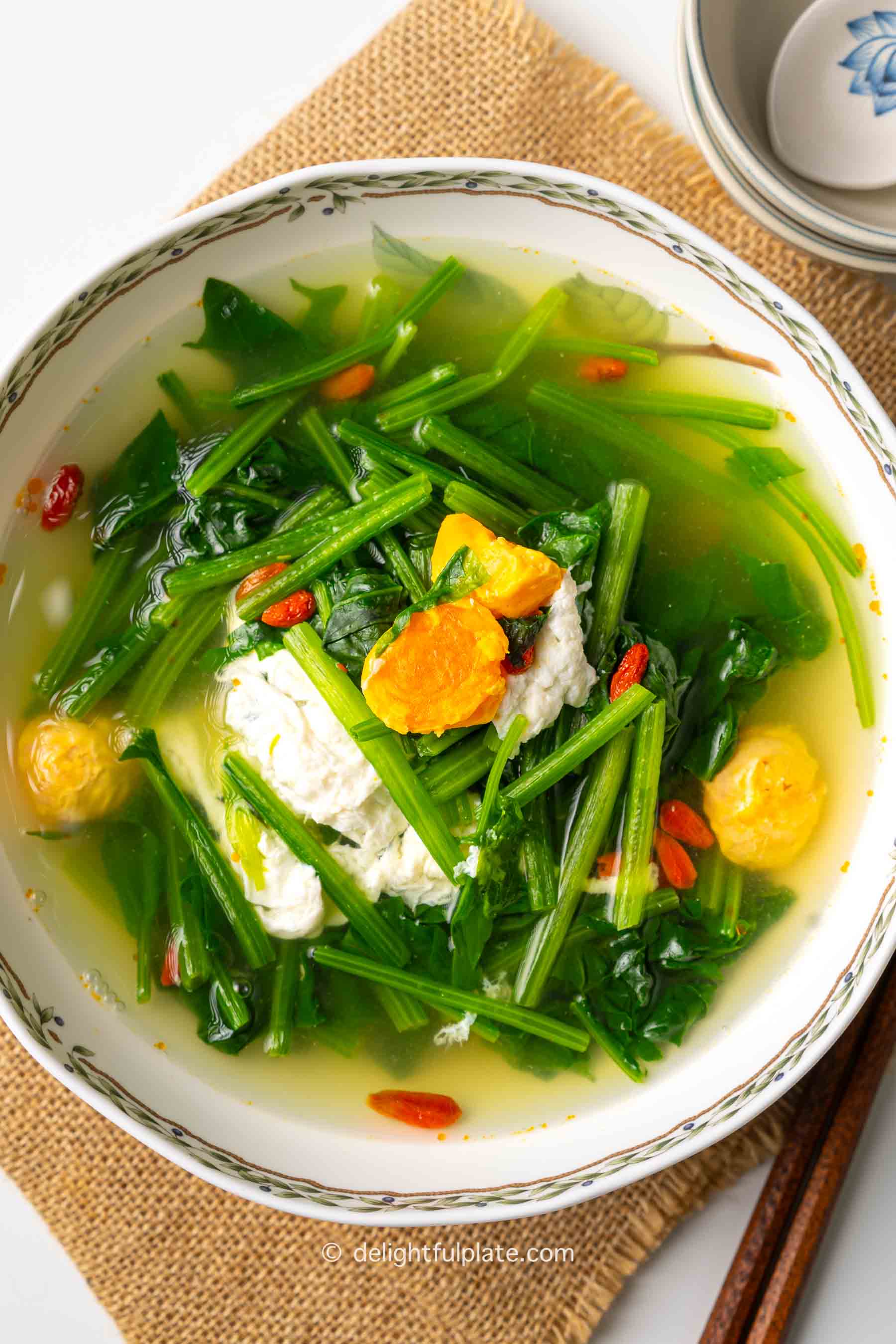 a bowl of Spinach Soup with Salted Duck Eggs and goji berries.
